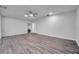 Large main bedroom with ceiling fan and wood-look vinyl flooring at 9100 52Nd N Way, Pinellas Park, FL 33782