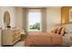 Bedroom with wood dresser and orange bedding at 9288 Bonita Mar Dr, Parrish, FL 34219