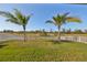 Large backyard with grassy area and white fence at 935 Signet Dr, Apollo Beach, FL 33572