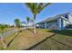 Spacious backyard with grassy area and palm trees at 935 Signet Dr, Apollo Beach, FL 33572