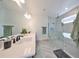 Modern bathroom with double vanity, large shower, and herringbone floor tile at 935 Signet Dr, Apollo Beach, FL 33572