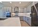 Modern kitchen with gray cabinets, quartz countertops, and herringbone floors at 935 Signet Dr, Apollo Beach, FL 33572