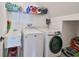 Laundry room with washer, dryer, and utility sink at 935 Signet Dr, Apollo Beach, FL 33572