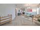 Bright living room with herringbone floors and a teal couch at 935 Signet Dr, Apollo Beach, FL 33572