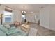 Living room with herringbone floors, a teal couch, and entryway view at 935 Signet Dr, Apollo Beach, FL 33572