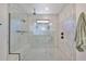 Large walk-in shower with marble tile and built-in seat at 935 Signet Dr, Apollo Beach, FL 33572