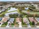 Aerial view of neighborhood with pond at 9551 Jaybird Ln, Land O Lakes, FL 34638