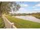 Spacious backyard with pond view and white fence at 9551 Jaybird Ln, Land O Lakes, FL 34638