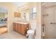 Bathroom with double vanity, toilet, shower, and access to bedroom at 9551 Jaybird Ln, Land O Lakes, FL 34638