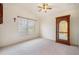 Bright bedroom with ceiling fan, large window, and display cabinet at 9551 Jaybird Ln, Land O Lakes, FL 34638