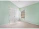 Spacious bedroom with double doors and a window at 9551 Jaybird Ln, Land O Lakes, FL 34638