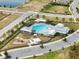 Aerial view of community pool, playground, and parking at 9551 Jaybird Ln, Land O Lakes, FL 34638