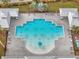 Community pool with lounge chairs and umbrellas at 9551 Jaybird Ln, Land O Lakes, FL 34638