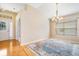 Bright dining room with hardwood floors and a view to the entryway at 9551 Jaybird Ln, Land O Lakes, FL 34638