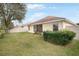 House exterior showcasing a well-manicured lawn at 9551 Jaybird Ln, Land O Lakes, FL 34638