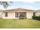 Back of house with screened porch and yard at 9551 Jaybird Ln, Land O Lakes, FL 34638