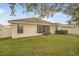 Back of house with screened patio and lawn at 9551 Jaybird Ln, Land O Lakes, FL 34638