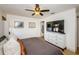 Spacious bedroom with king-size bed and large TV at 9607 Maxson Dr, Land O Lakes, FL 34638