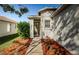 Inviting front entrance with landscaping and a wreath on the door at 9607 Maxson Dr, Land O Lakes, FL 34638