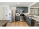 Modern kitchen with stainless steel appliances and gray cabinets at 9607 Maxson Dr, Land O Lakes, FL 34638