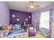 Purple bedroom with a twin bed, beanbag chair, and window coverings at 4762 White Sanderling Ct, Tampa, FL 33619