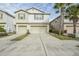 Two-story townhome with two-car garage and landscaped front yard at 4762 White Sanderling Ct, Tampa, FL 33619