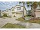 Two-story townhome with a two-car garage, driveway and palm trees at 4762 White Sanderling Ct, Tampa, FL 33619