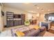 Open living room features a leather couch, a green accent chair, and built-in shelving at 4762 White Sanderling Ct, Tampa, FL 33619