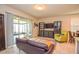 Bright living room with sliding doors to a screened lanai, leather couch and green armchair at 4762 White Sanderling Ct, Tampa, FL 33619