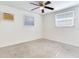 Bright bedroom with ceiling fan, window, and speckled carpet at 10463 118Th Ave, Largo, FL 33773