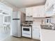 Kitchen with stainless steel appliances and white cabinets at 10463 118Th Ave, Largo, FL 33773