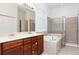 Primary bathroom with double vanity and walk-in shower at 10721 Rockledge View Dr, Riverview, FL 33579