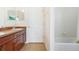 Bathroom with double vanity, door, and tub at 10721 Rockledge View Dr, Riverview, FL 33579