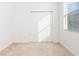 Empty bedroom with carpeted floor, closet, and window at 10721 Rockledge View Dr, Riverview, FL 33579