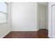 Empty bedroom with wood floors, window, and door at 10721 Rockledge View Dr, Riverview, FL 33579