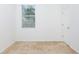 Empty bedroom with carpeted floor, window, and door at 10721 Rockledge View Dr, Riverview, FL 33579