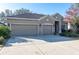 Three-car garage house with a tan exterior at 10721 Rockledge View Dr, Riverview, FL 33579