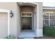 Dark brown front door entryway with sidelights at 10721 Rockledge View Dr, Riverview, FL 33579