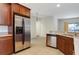 Stainless steel appliances and wood cabinets in this well-lit kitchen at 10721 Rockledge View Dr, Riverview, FL 33579