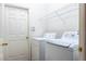 Bright laundry room with washer, dryer, and shelving at 10721 Rockledge View Dr, Riverview, FL 33579