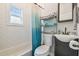 Clean bathroom with white subway tiles, a shower/tub combo, and modern vanity at 111 W Ida St, Tampa, FL 33603