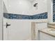 Updated bathroom with subway tile shower and decorative mosaic accents at 111 W Ida St, Tampa, FL 33603