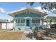 Charming bungalow with a teal exterior, white trim, and a welcoming front porch at 111 W Ida St, Tampa, FL 33603