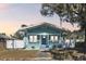 Quaint light blue house with white porch and fenced yard in the evening at 111 W Ida St, Tampa, FL 33603