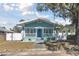 Charming light blue house with white trim, front porch, and a landscaped yard at 111 W Ida St, Tampa, FL 33603