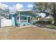 Light blue house with white trim and porch, showcasing a well-maintained yard at 111 W Ida St, Tampa, FL 33603