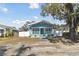 Cute light blue house with white porch and fenced yard on a sunny day at 111 W Ida St, Tampa, FL 33603