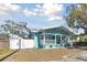 Light blue house with white trim and porch, showcasing a well-maintained yard at 111 W Ida St, Tampa, FL 33603