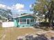 Charming teal bungalow with white trim and a porch at 111 W Ida St, Tampa, FL 33603