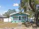 Quaint teal house with white porch and fenced yard at 111 W Ida St, Tampa, FL 33603